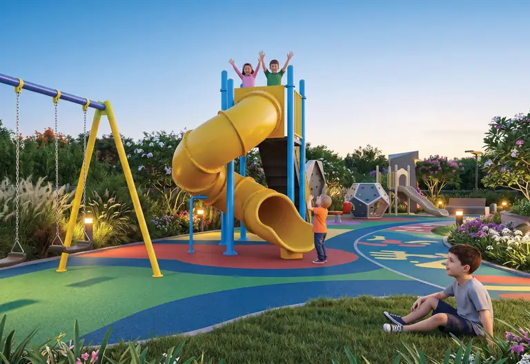 Children on the play area slide and swings at Prime Mundhwa